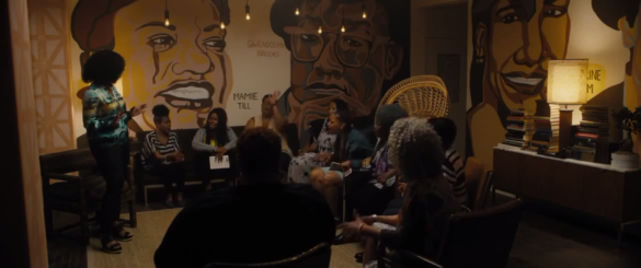 A group of women gather in a secret back room in a bookstore to discuss their protest plans. A mural depicting famous African American women covers the walls of the room.